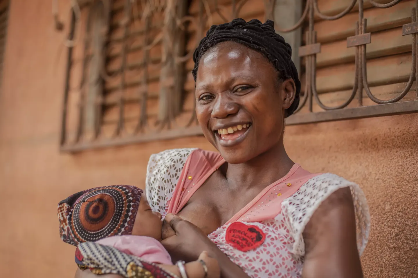 Smiling woman breastfeeding her baby